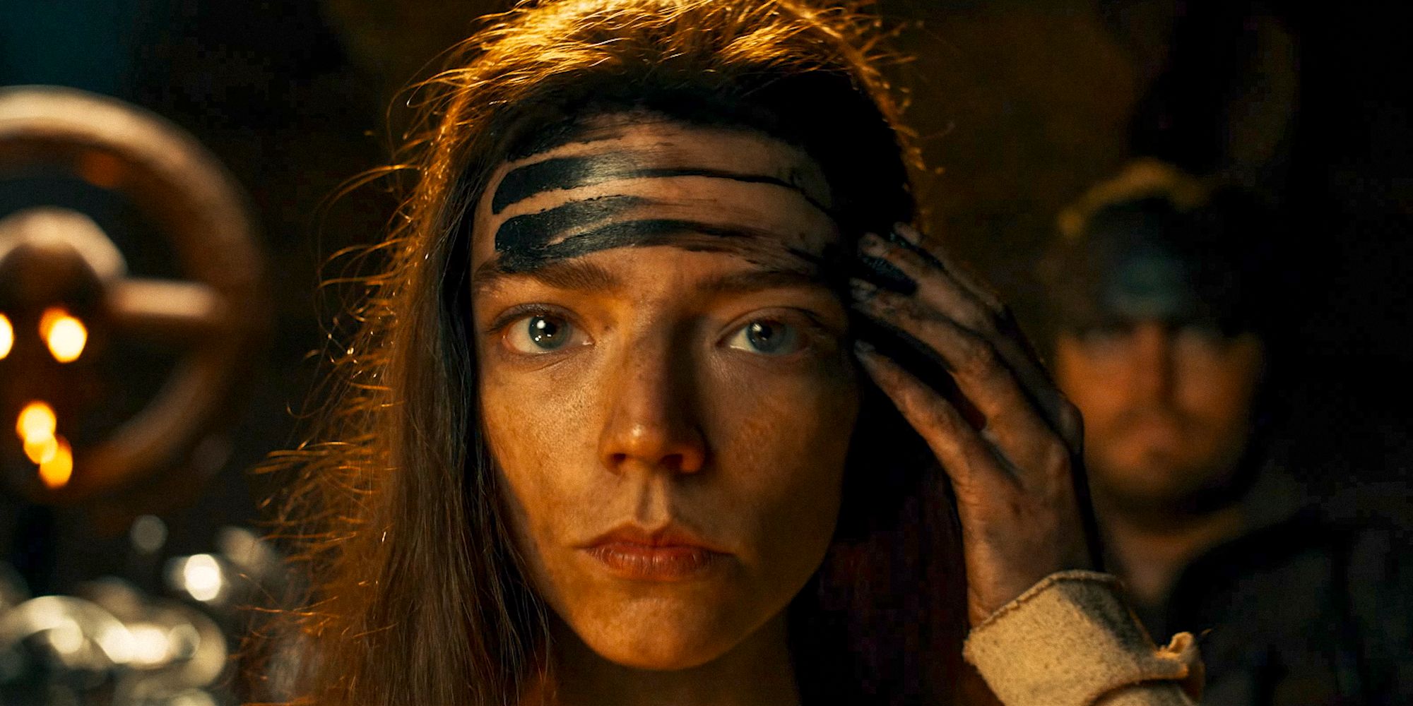 Furiosa putting some oil in her forehead in Furiosa: A Mad Max Saga