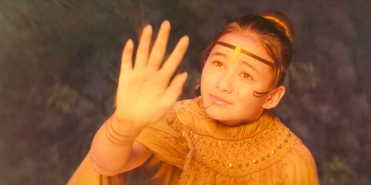 Kaylee Hottle as Jia holding her hand in the air from Godzilla x Kong: The New Empire