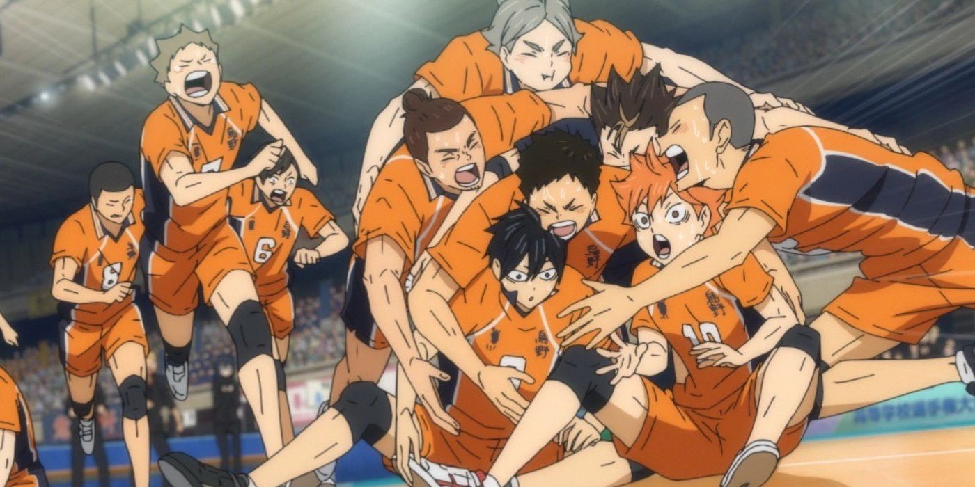 Haikyuu's characters all crying and hugging each other on the volleyball court.