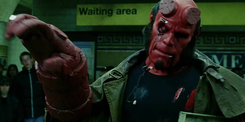 Ron Perlman as Hellboy adjusting his stone hand in Hellboy (2004)
