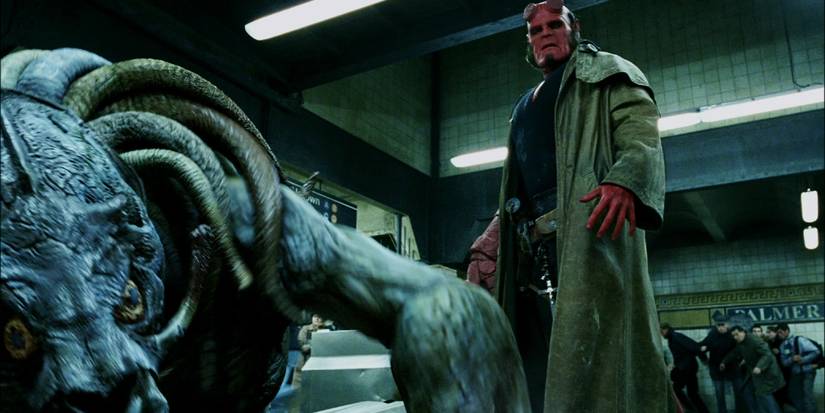 Ron Perlman as Hellboy standing over a defeated monster in the subway fight scene in Hellboy (2004)