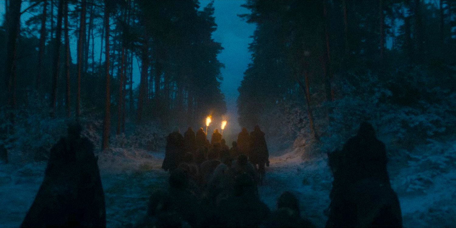 A procession walking through the forest at night in House of the Dragon - season 2