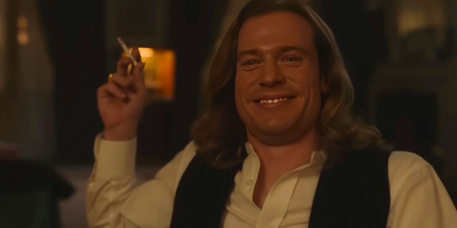 Sam Reid as Lestat de Lioncourt with a mocking smile while smoking a cigarette in Interview with the Vampire season 2