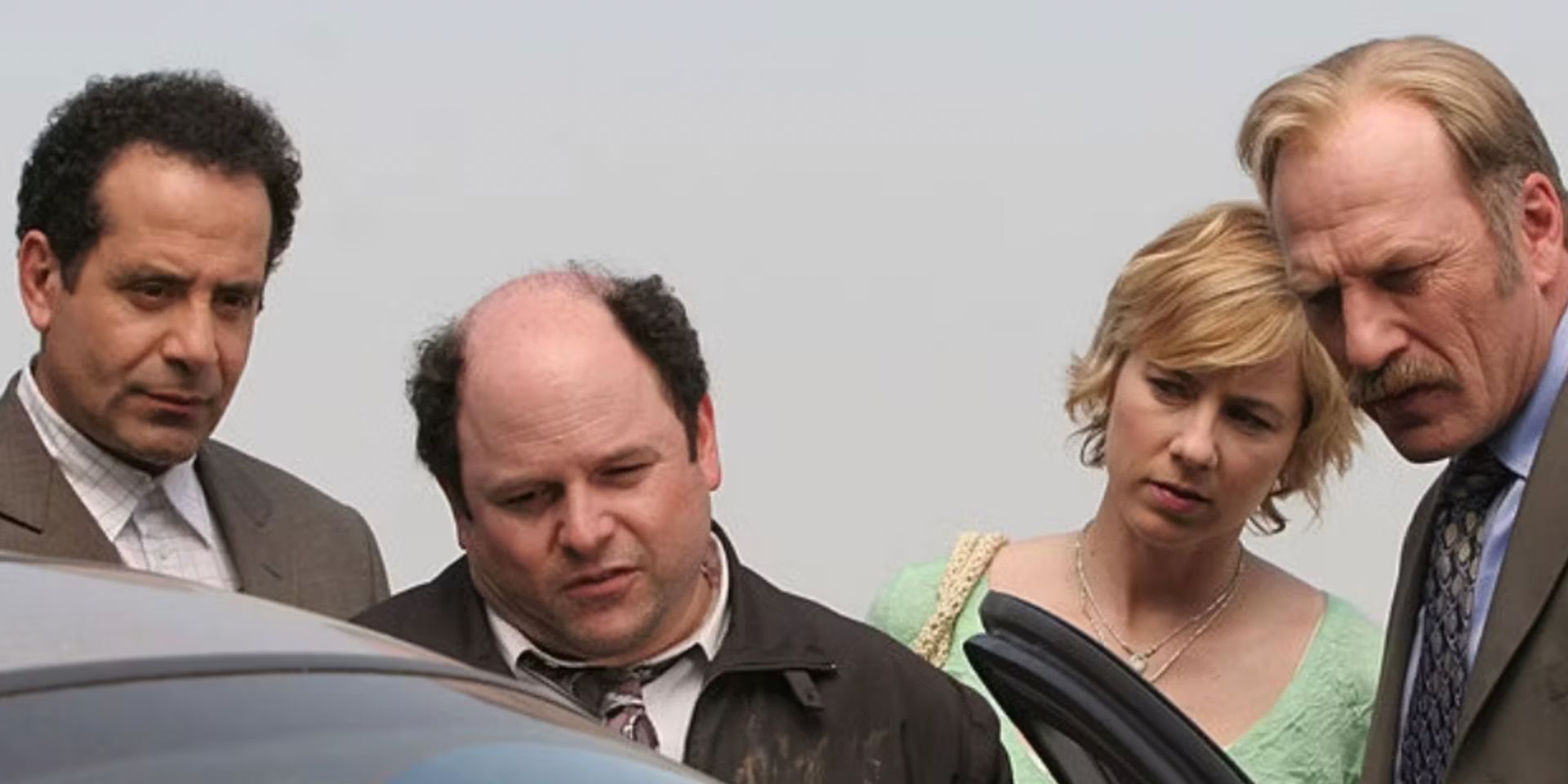 Jason Alexander is led into a car by cast members in 'Monk'