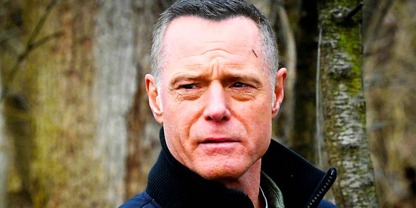 Jason Beghe as Hank Voight looking on with concern in the woods in Chicago PD