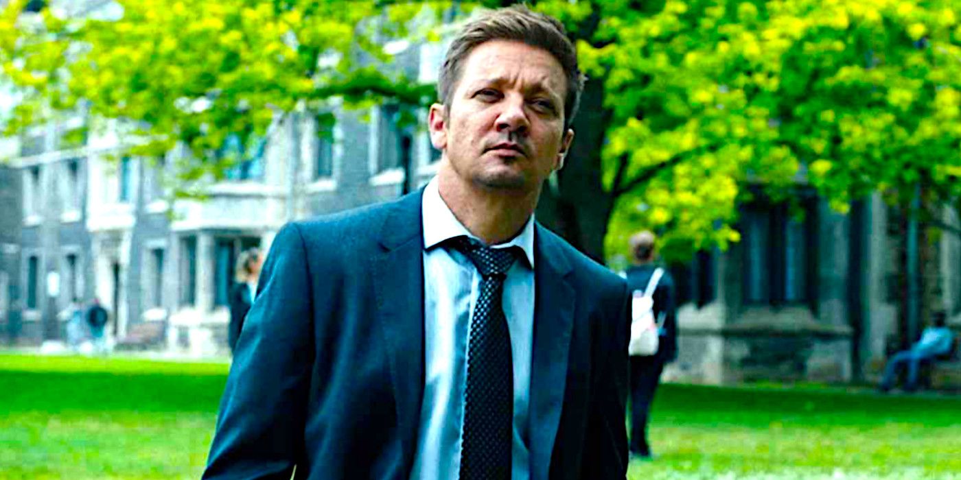 Jeremy Renner standing in a park in a suit in Mayor of Kingstown