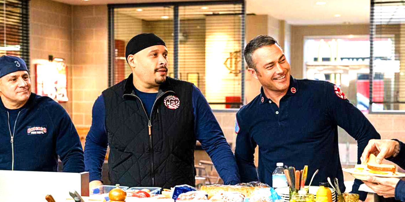 Joe Mińoso as Cruz and Taylor Kinney as Severide standing at a table at the Firehouse in Chicago Fire