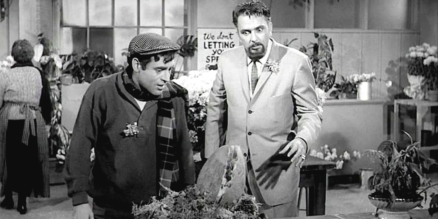 Jonathan Haze and Mel Welles inspect a giant Venus flytrap-like plant in a scene from Little Shop of Horrors 1960