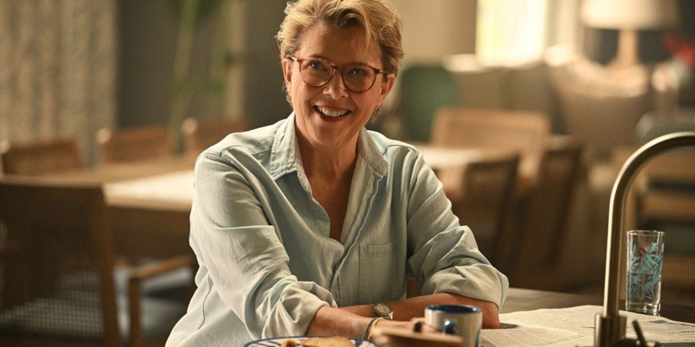 Annette Bening as Joy Delaney sitting at a table and smiling in Apples Never Fall