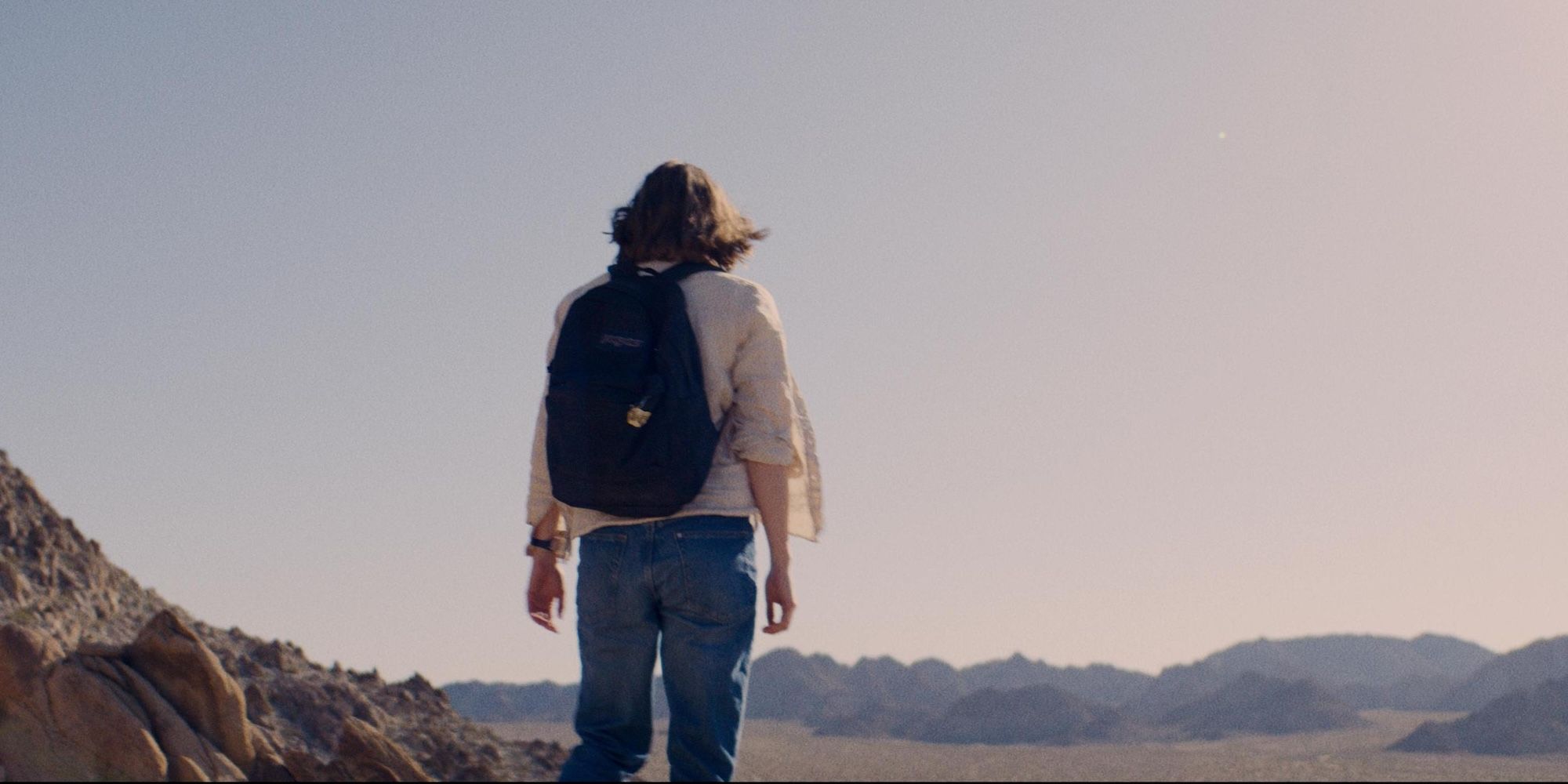 Kristine Froseth stares into the endless desert in Desert Road movie