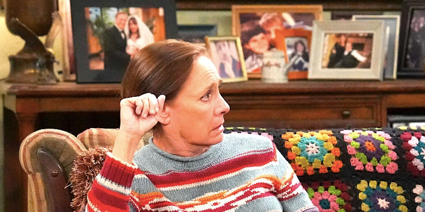 Laurie Metcalf's Jackie sits on a couch looking worried in The Conners