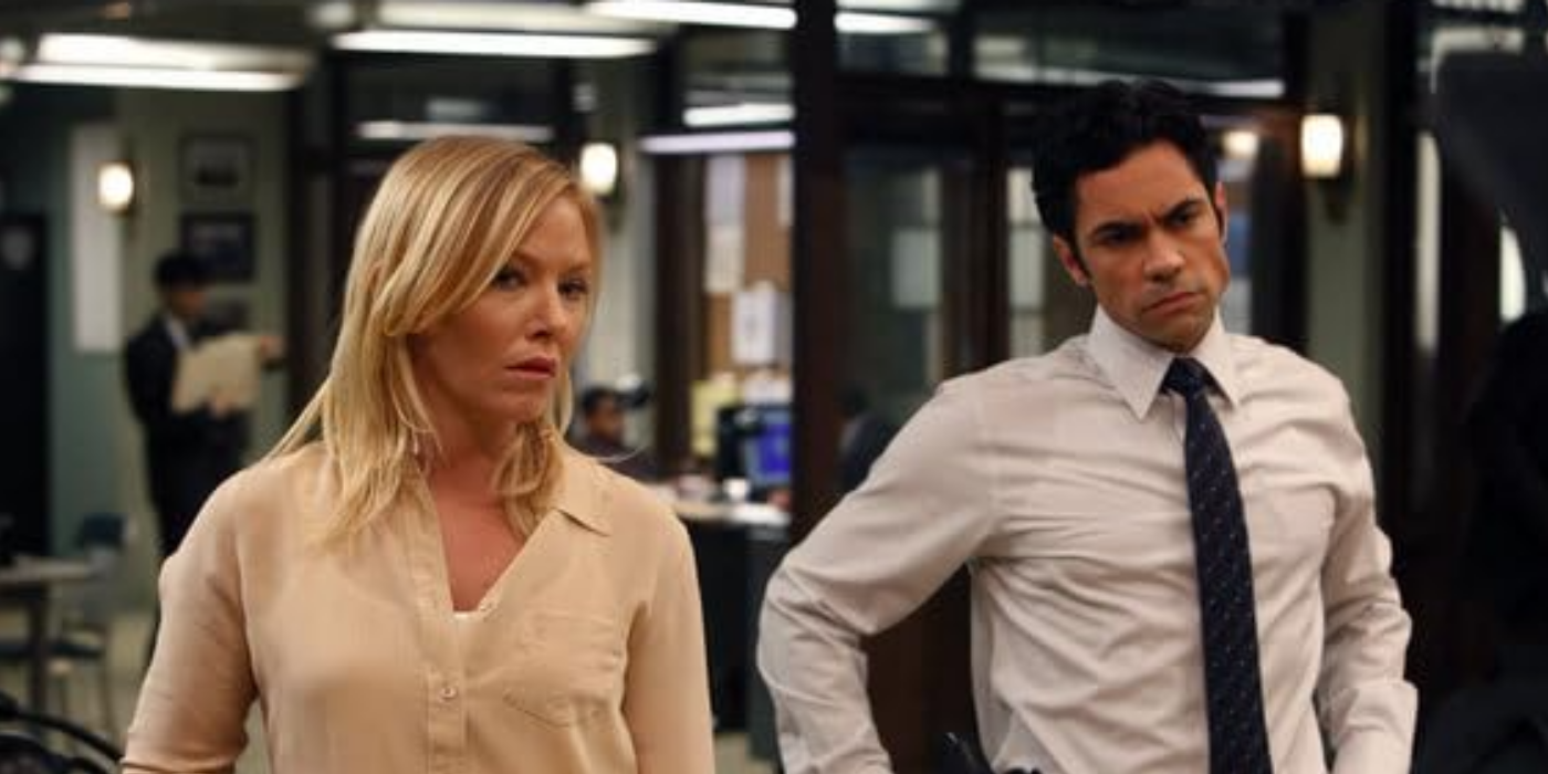 Rollins and Amaro listening to someone off screen in the SVU episode Blood Brothers