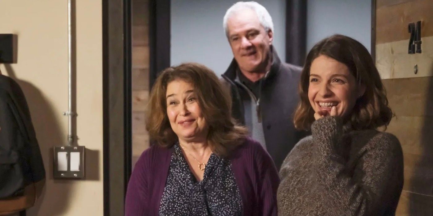 Lea excitedly standing at the door with her parents. 
