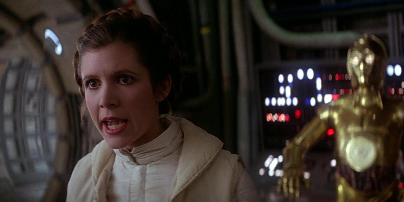 Leia Organa (Carrie Fisher) yelling offscreen with C3-PO standing in the background while on the Millennium Falcon in Star Wars: Episode V - The Empire Strikes Back