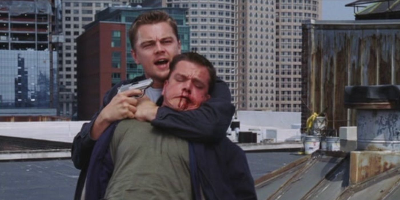 Leonardo DiCaprio points a gun at Matt Damon's head in The Departed