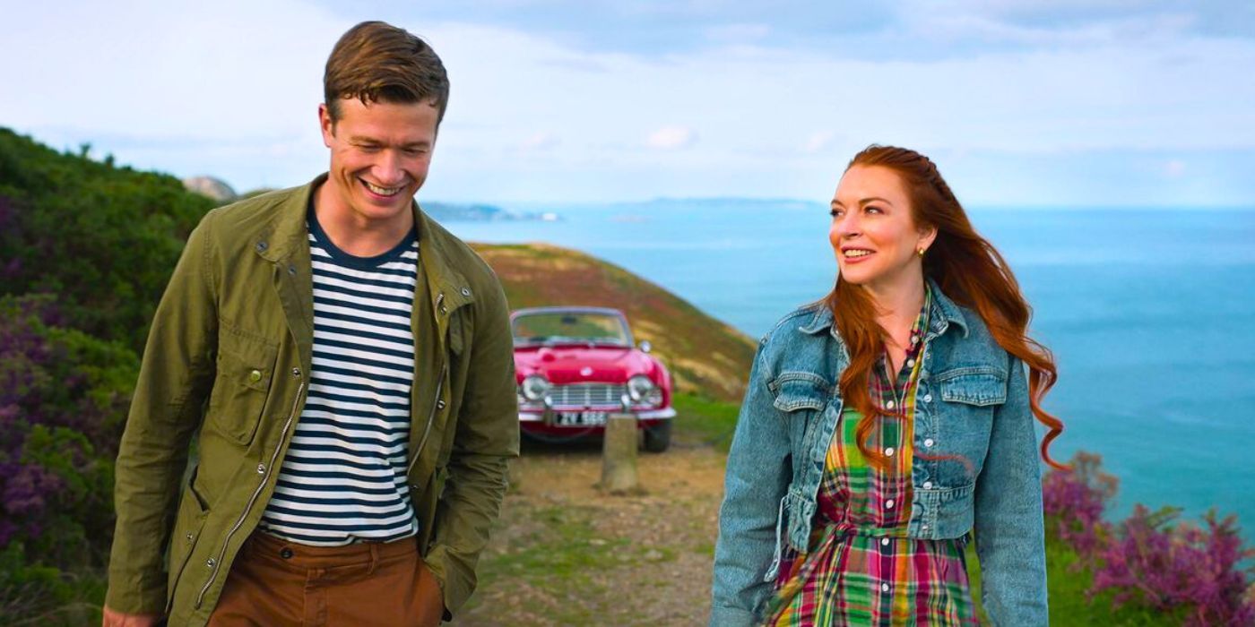 Lindsay Lohan as Maddie and Ed Speleers as James walking along the cliffs in Irish Wish