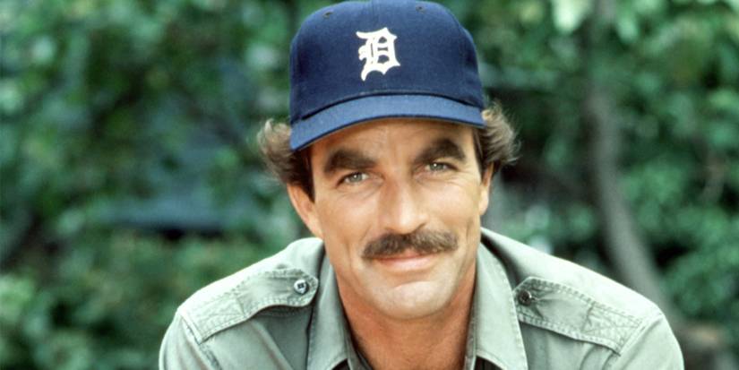 Tom Selleck as Thomas Magnum, wearing a baseball cap and smiling
