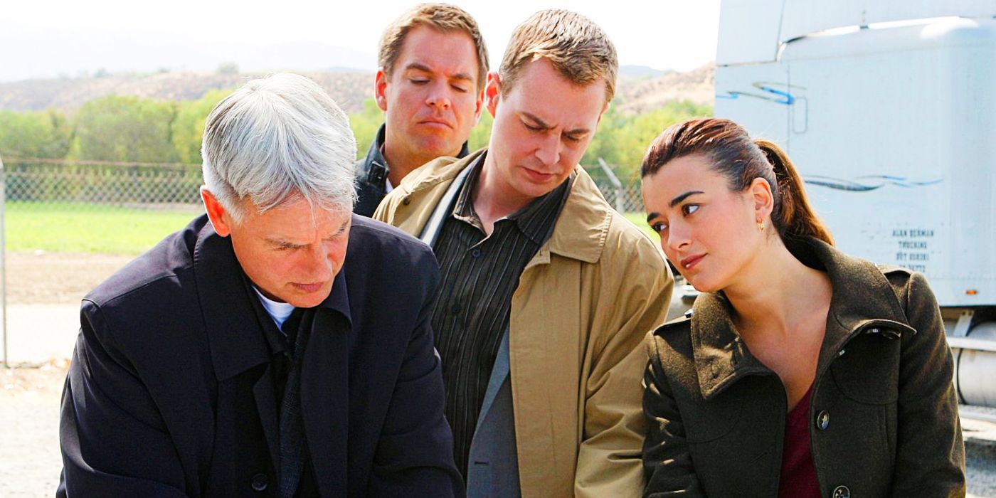 Leory Gibbs, Anthony DiNozzo, Timothy McGee, and Ziva David are gathered to look at something. Gibbs, DiNozzo, and McGee look down and David looks to the right, at Gibbs.