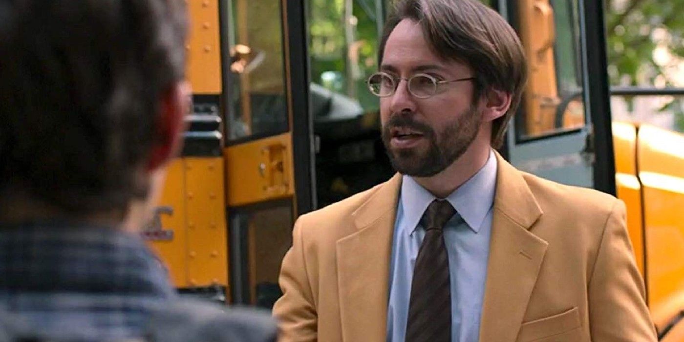 Martin Starr as Roger Harrington standing in front of a school bus in spider-man far from home