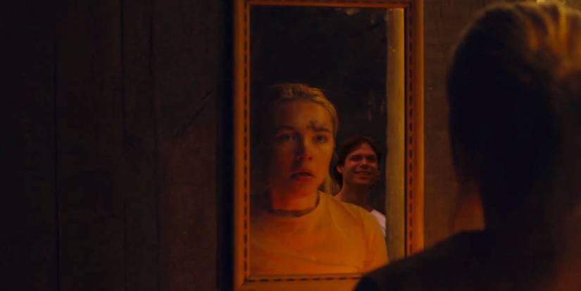Florence Pugh looking into a mirror in shock in Midsommar 