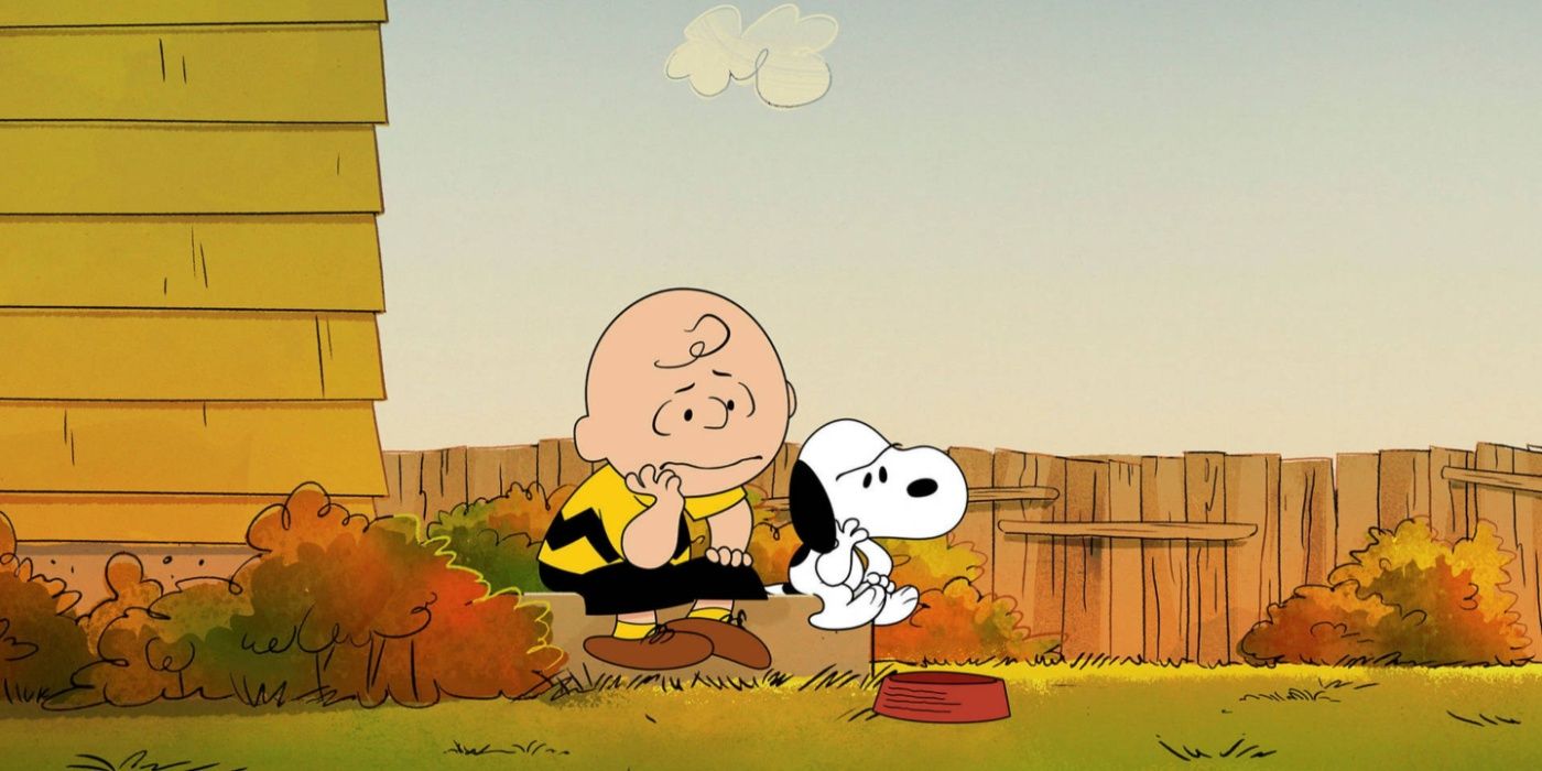 Peanuts, Snoopy and Charlie Brown sitting sadly on a stoop.