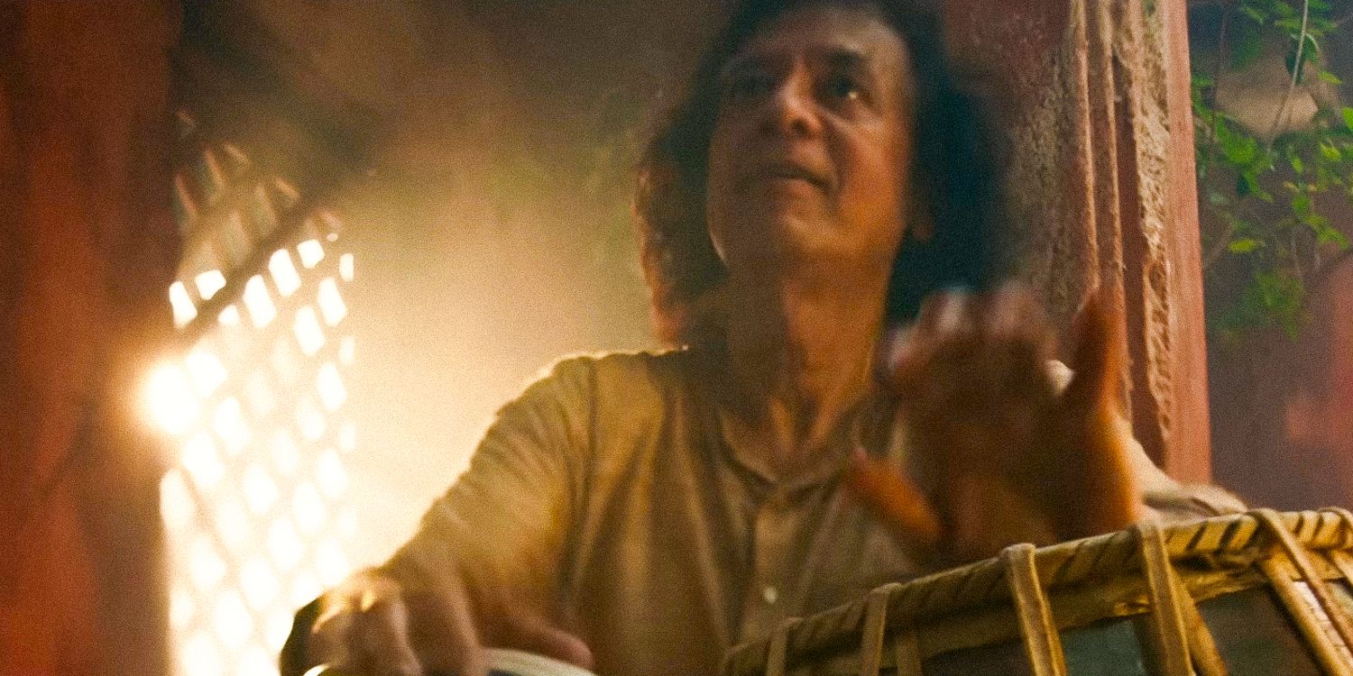 Shot of a man playing percussion instrument in Monkey Man trailer 2