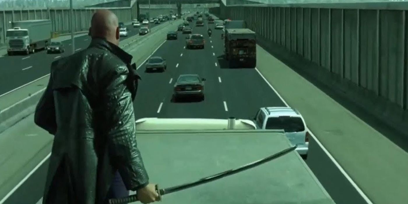 Morpheus standing on a truck during the freeway chase scene in The Matrix Reloaded