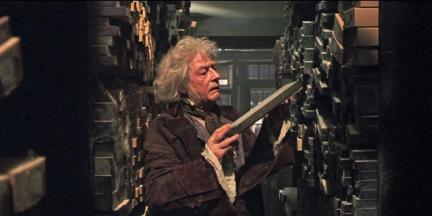 Mr. Ollivander (John Hurt) searching shelves for a wand in Harry Potter and the Sorcerer's Stone.