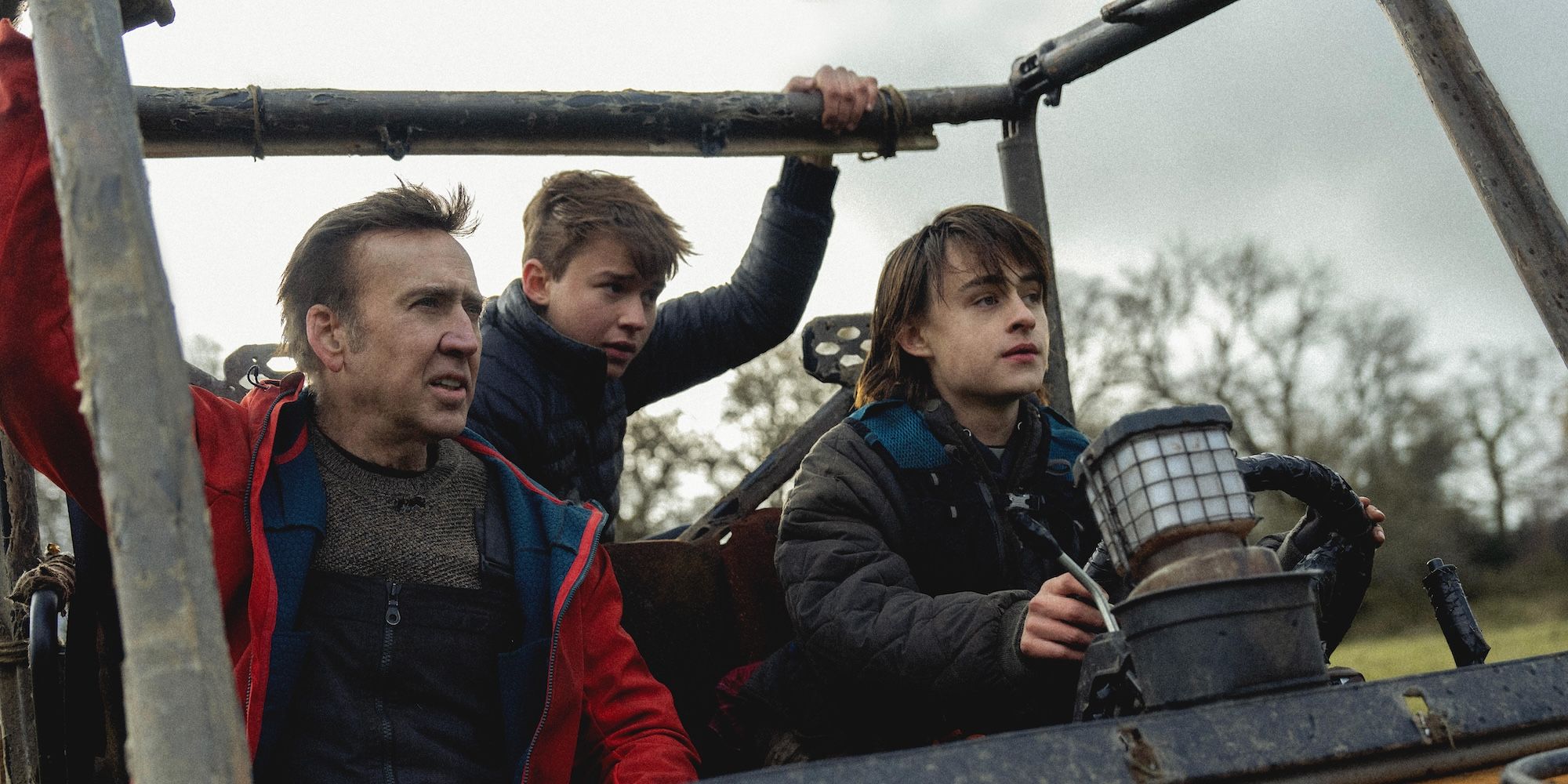 Nicolas Cage rides in a truck with his onscreen sons in Arcadian movie still