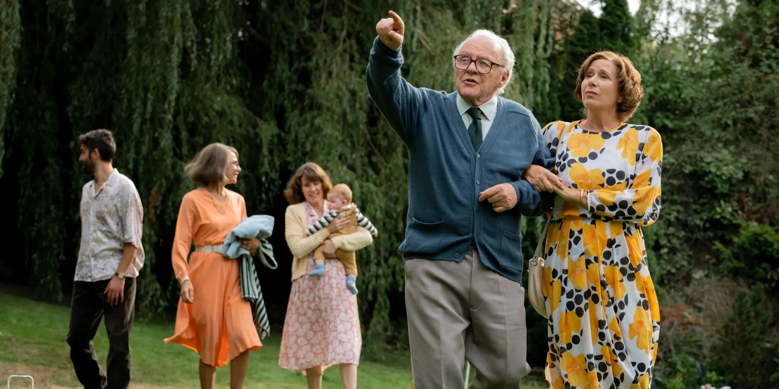 One Life 2024 Anthony Hopkins and Helena Bonham Carter walk arm in arm with their family behind them 