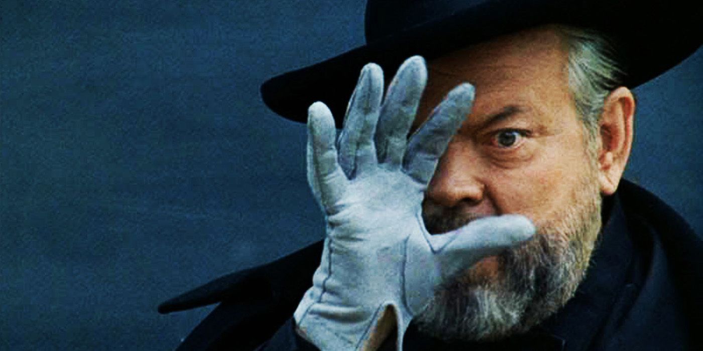 Orson Welles holding his hand up in an F for Fake 