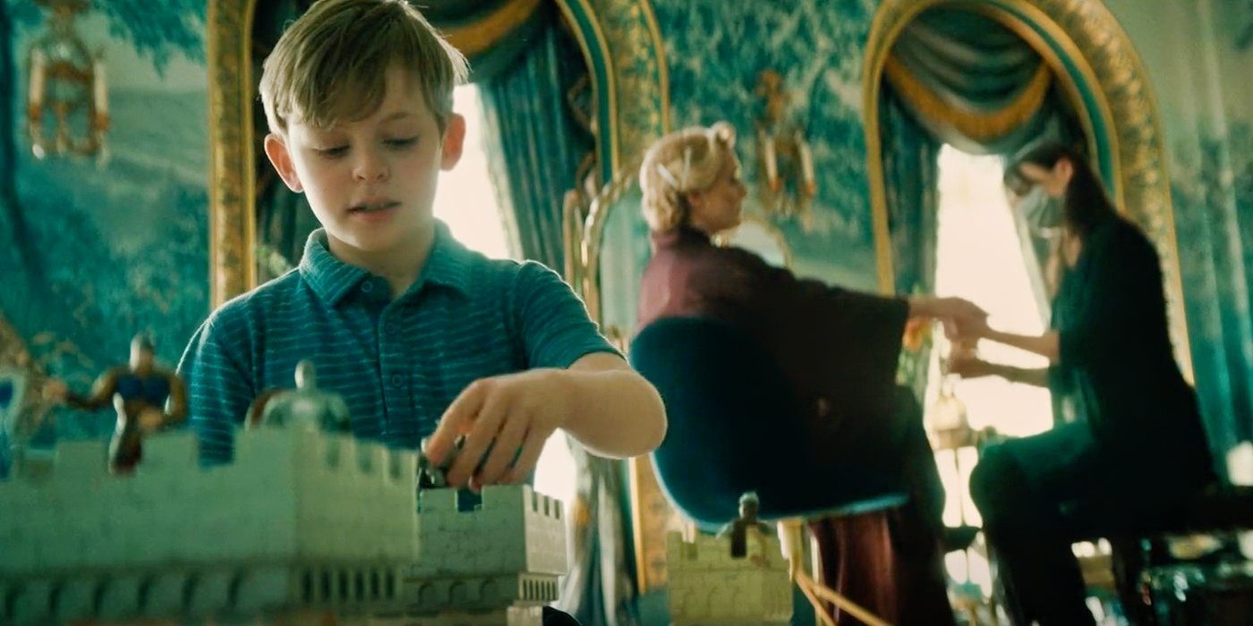 Oscar playing with toys in the Chancellor's room in The Regime