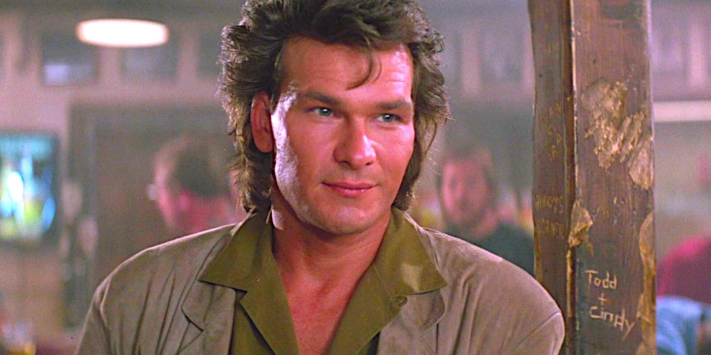 Patrick Swayze looks straight ahead while smirking slightly in a scene from Road House 1989.