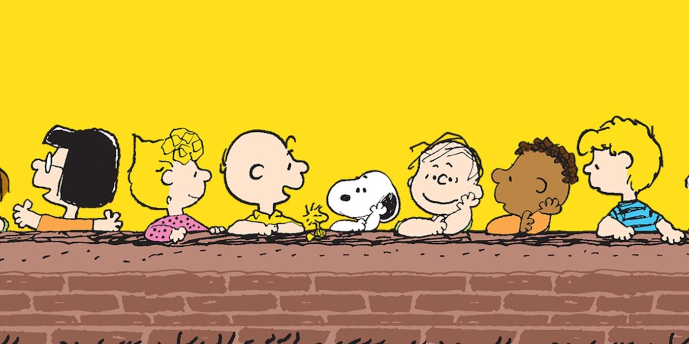 Peanuts Gang sitting at a brick wall