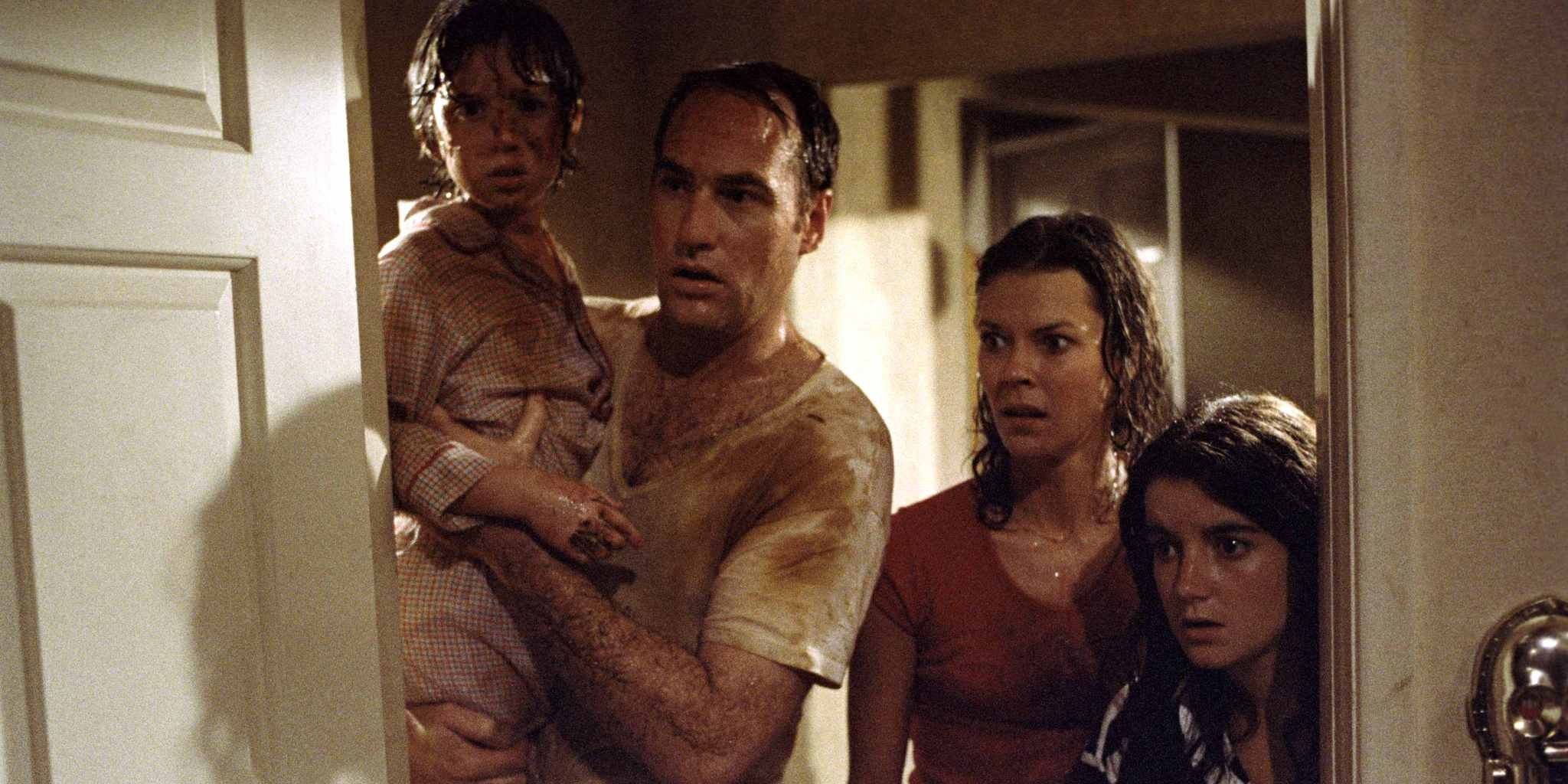 The Freeling family covered in dirt look through a doorway in shock in Poltergeist