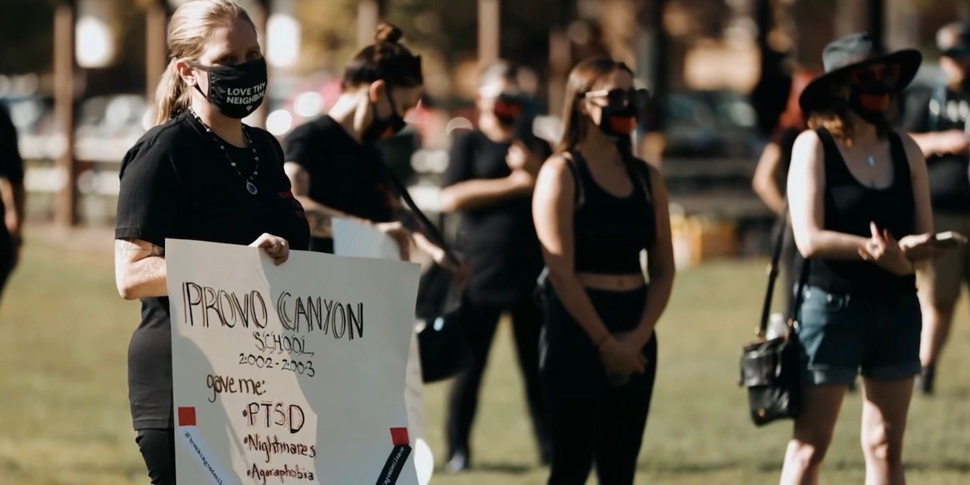 A protester is holding up a sign. 