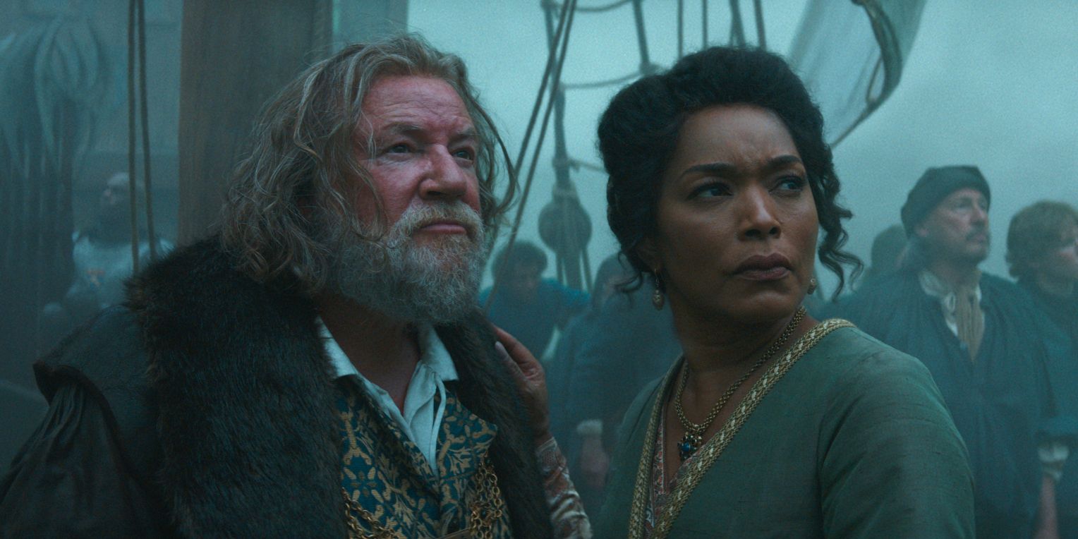 Ray Winstone and Angela Bassett standing together on a ship in Damsel