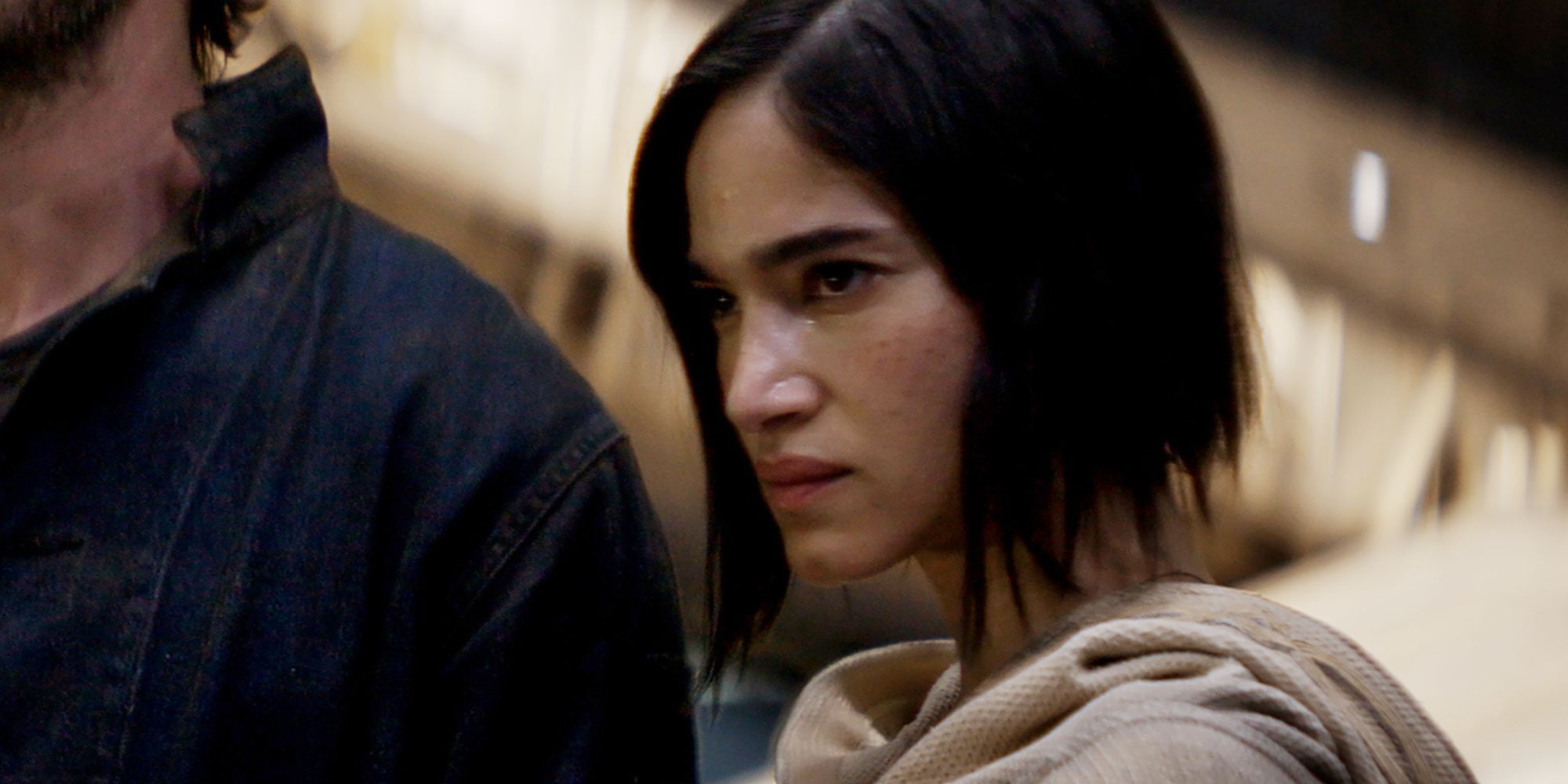 Sofia Boutella as Kora looking at something with suspicion in Rebel Moon