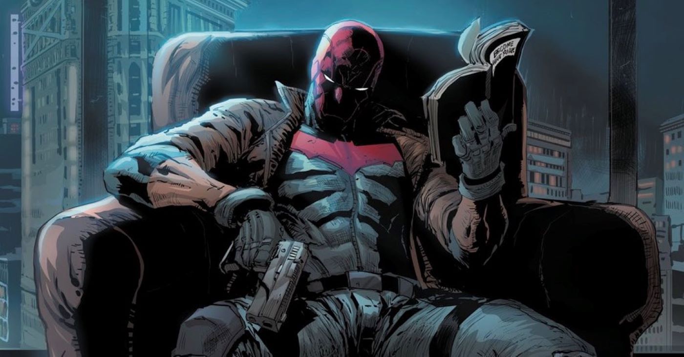 Red Hood reading a book and holding a gun while sitting in a chair