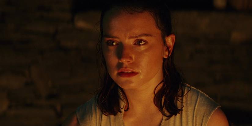 Rey looking upset with tears in her eyes in The Last Jedi