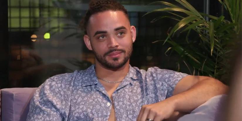 Rob Warne In 90 Day Fiance wearing unbuttoned printed shirt and looking at Sophie's friend Callum