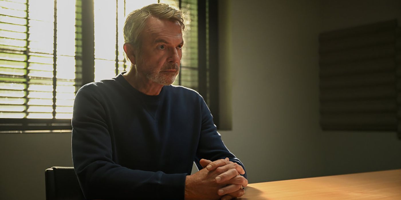 Sam Neill como Stan sentado em uma sala de interrogatório em Apples Never Fall