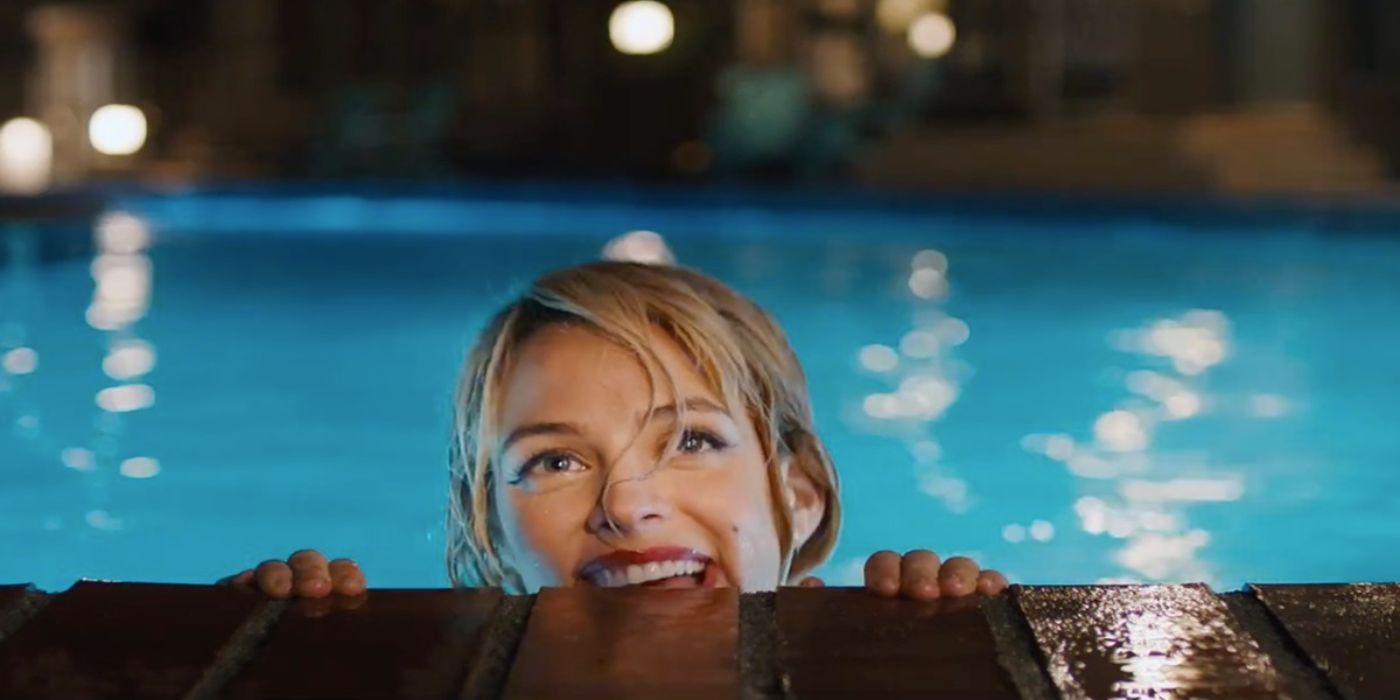 Sarah (Riley Keough) peering out of the pool in Under the Silver Lake.