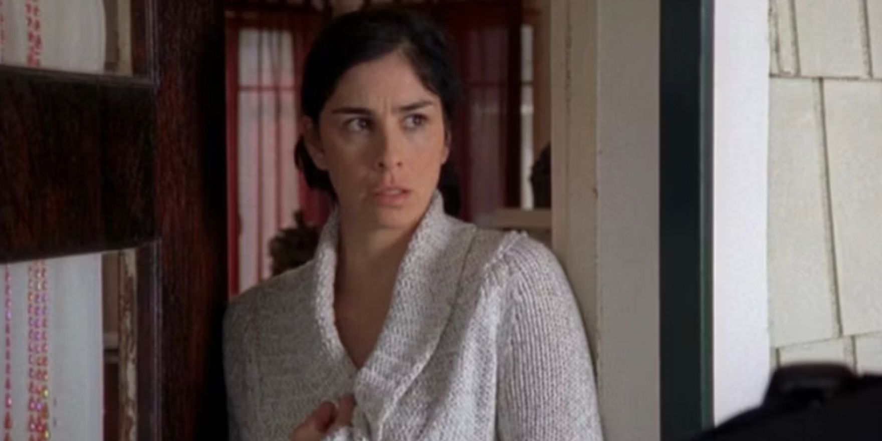 Sarah Silverman clutches her sweater in an episode of 'Monk'