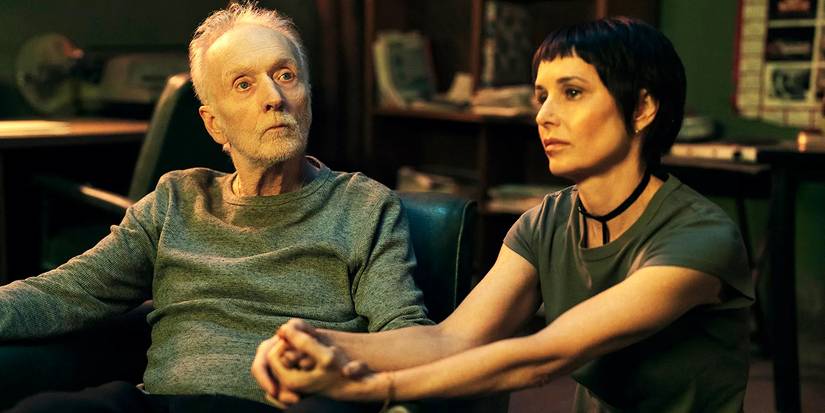 John and Amanda sit holding hands in Saw X