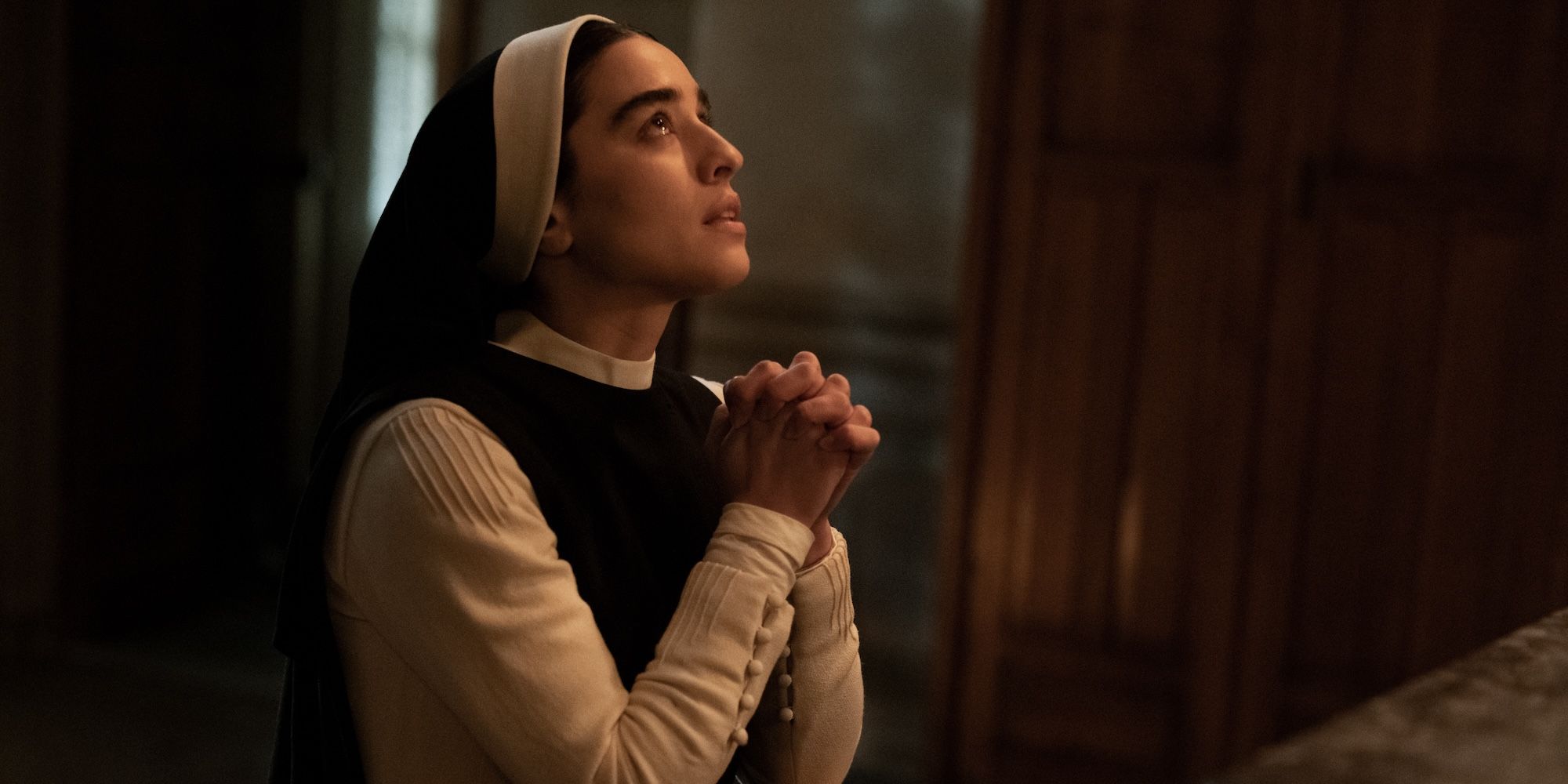 Simona Tabasco as Sister Mary prays in a scene from Immaculate