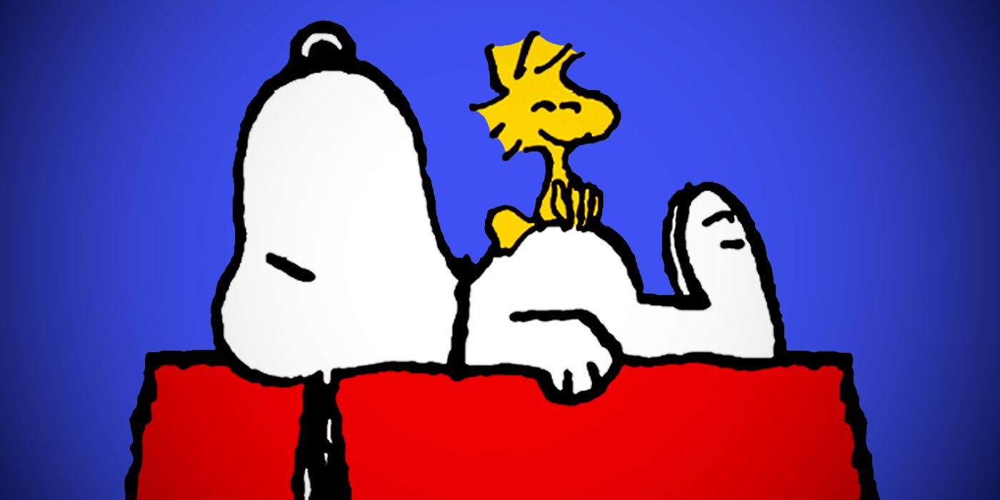 Woodstock stands on Snoopy's stomach atop his doghouse in Peanuts comic art