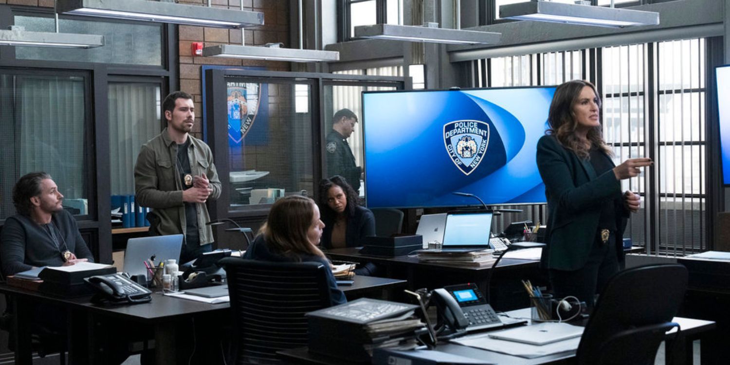 SVU Squad Room Benson makes a presentation. She has a computer screen with the NYPD logo behind her. Valesco is standing up behind her. Sykes, Curry, and Bruno are sitting at their desks.