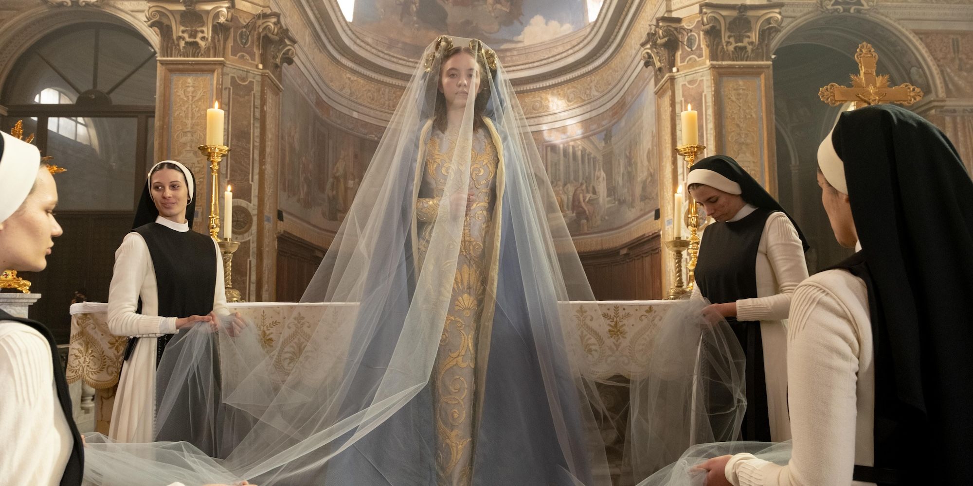 Sydney Sweeney's Sister Cecilia decked out on a dress and veil surrounded by nuns in Immaculate