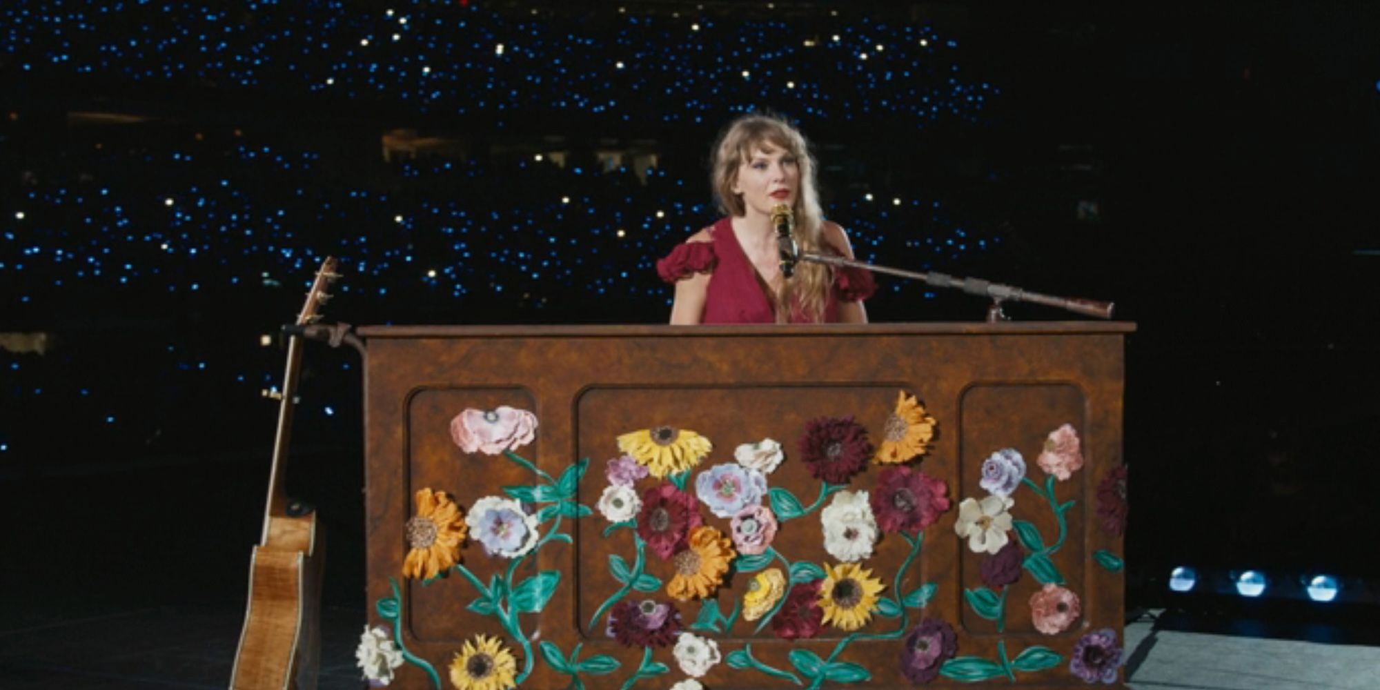 Taylor Swift sits at the piano during the acoustic set of the Eras Tour